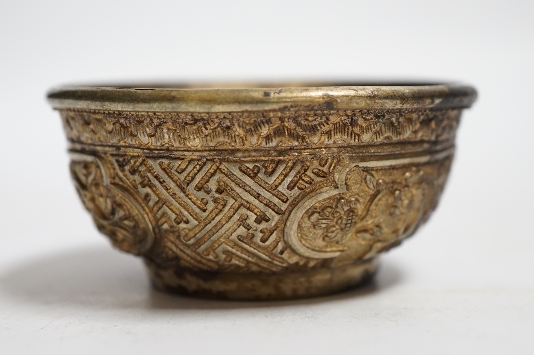 A Nepalese white metal tea bowl, 7.5cm diameter